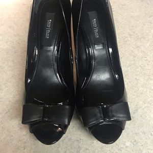 Woman’s black heals with bow.